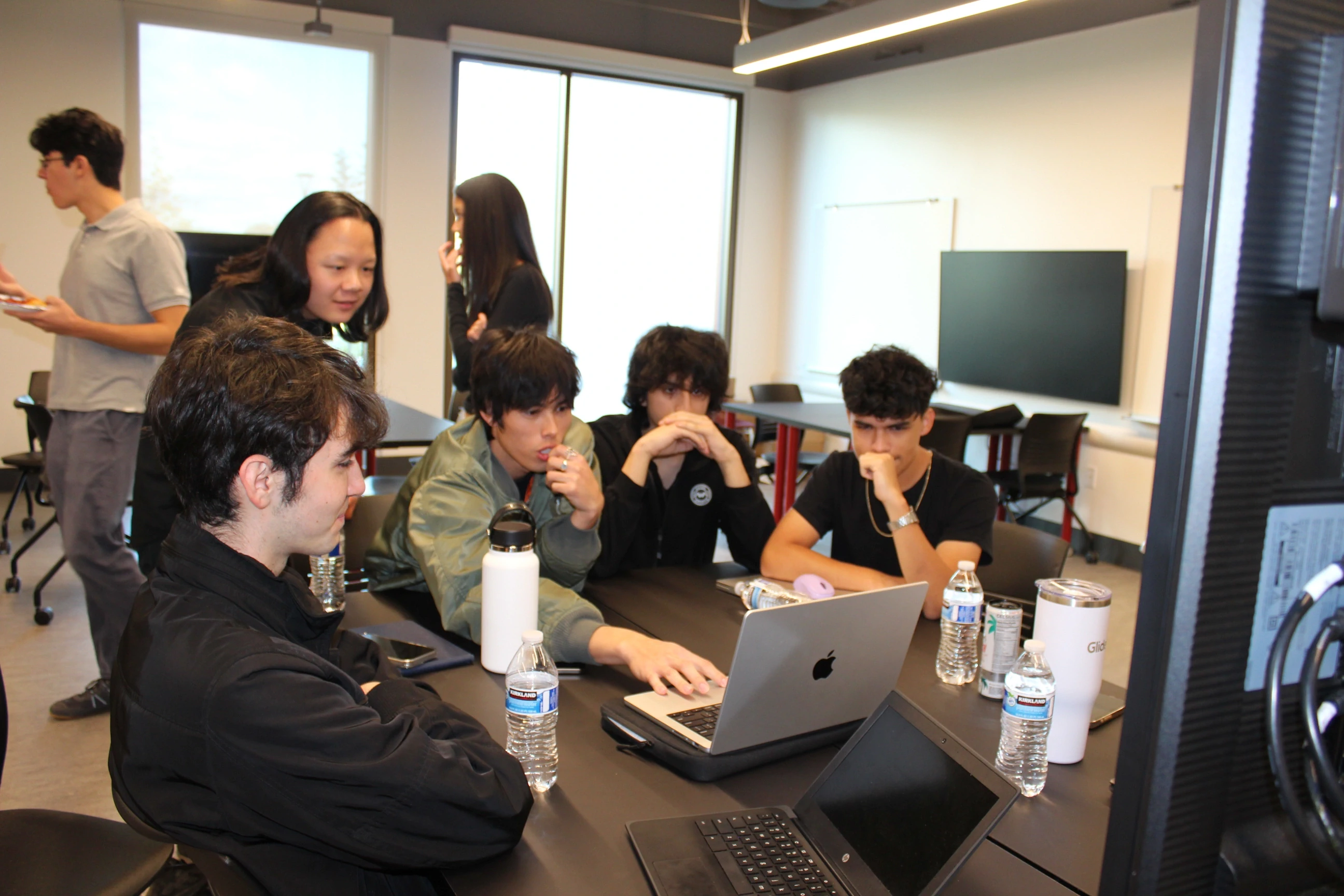 Group huddled around computer